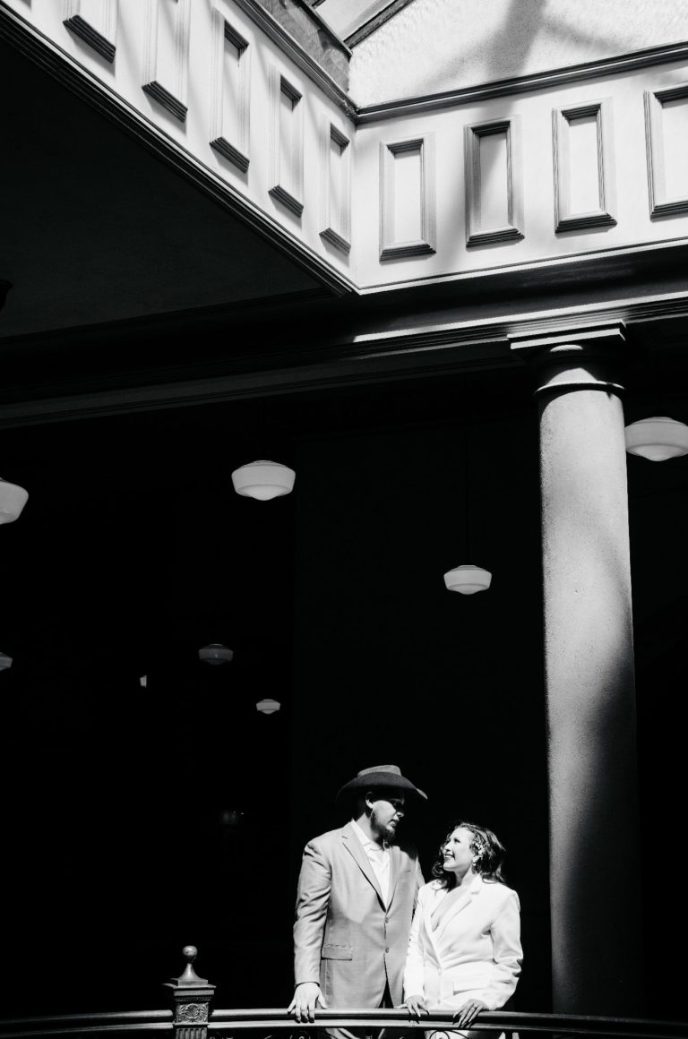Newlyweds embracing in front of the Tarrant County Courthouse in Downtown Fort Worth