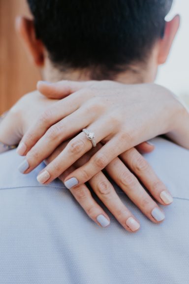 Engaged couple smiling at each other during a Fort Worth photo session