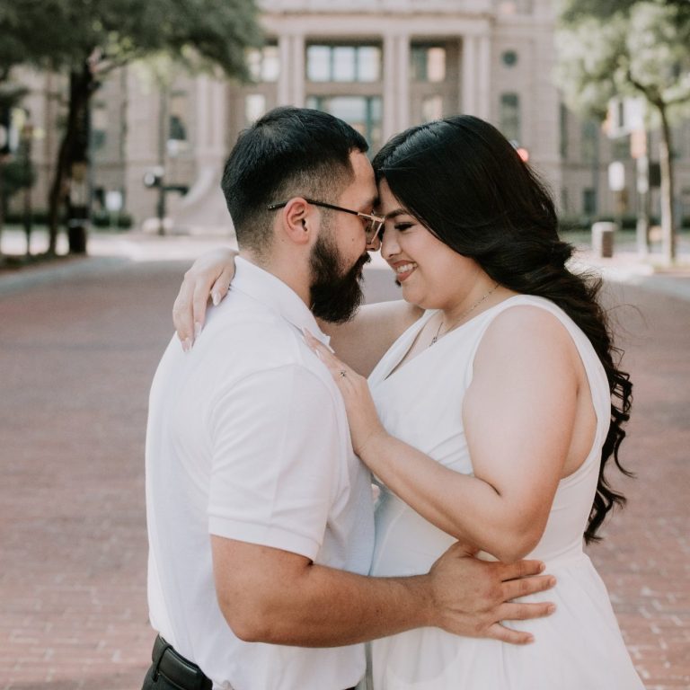Engaged couple embracing during a Downtown Fort Worth portrait session