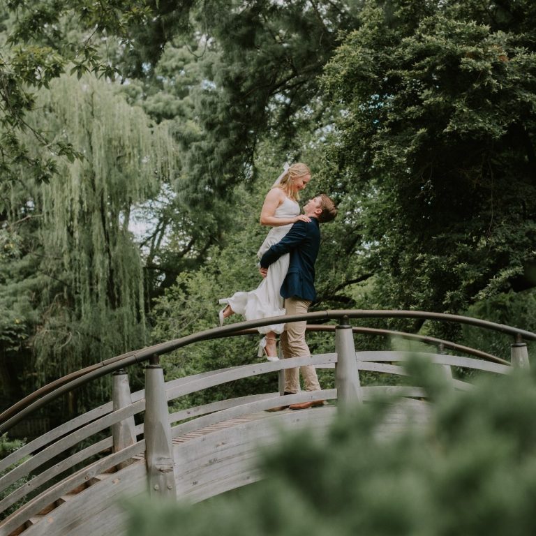 Engaged couple surrounded by seasonal greenery at the Fort Worth Botanic Garden